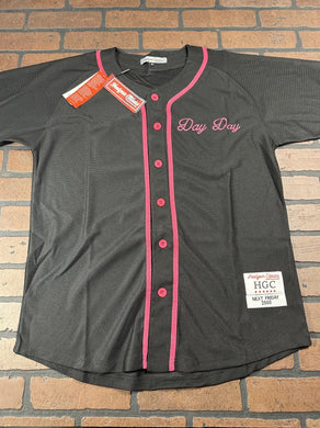 Black baseball jersey with pink accents on a brick background