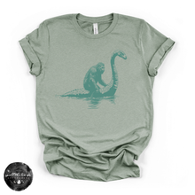 Load image into Gallery viewer, Bigfoot Riding Nessy Tee | Funny Cryptid Graphic T-Shirt