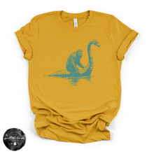 Load image into Gallery viewer, Bigfoot Riding Nessy Tee | Funny Cryptid Graphic T-Shirt
